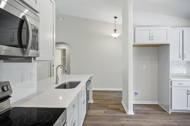 kitchen featuring hanging light fixtures, appliances with stainless steel finishes, sink, and white cabinetry