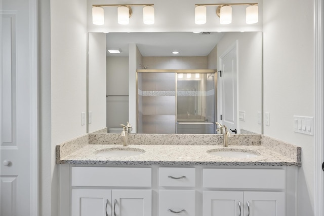 bathroom featuring vanity and an enclosed shower