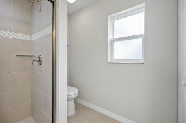 bathroom featuring tile patterned floors, toilet, and an enclosed shower