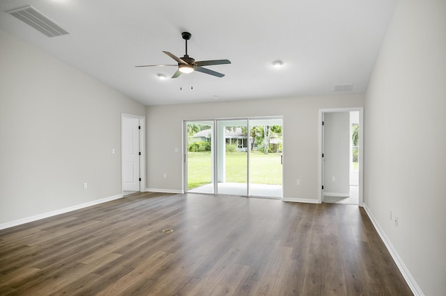 spare room with ceiling fan, vaulted ceiling, and dark hardwood / wood-style floors