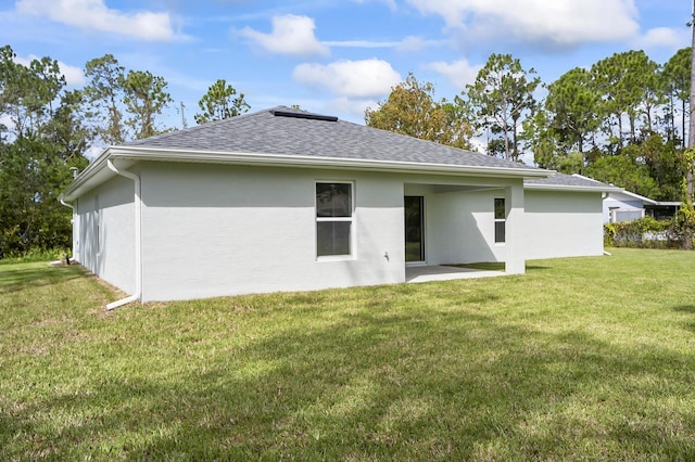 back of house with a yard