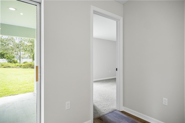 hallway with dark wood-type flooring