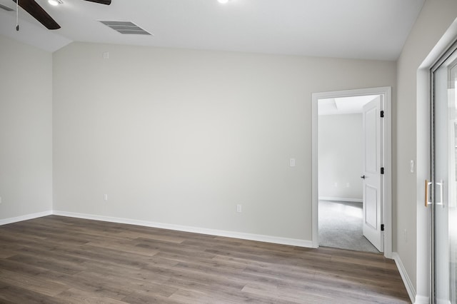 empty room featuring lofted ceiling and wood-type flooring