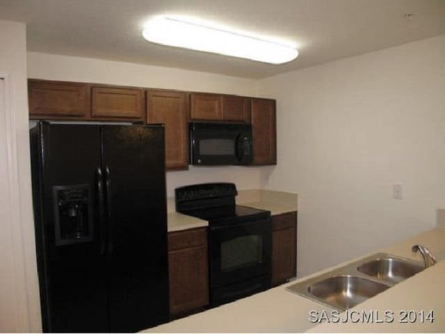 2550 Golden Lake Loop, Saint Augustine, FL 32084 - kitchen with black appliances and light countertops