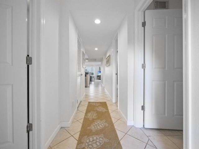 hall with light tile patterned floors