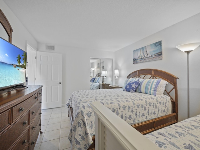 tiled bedroom featuring a closet