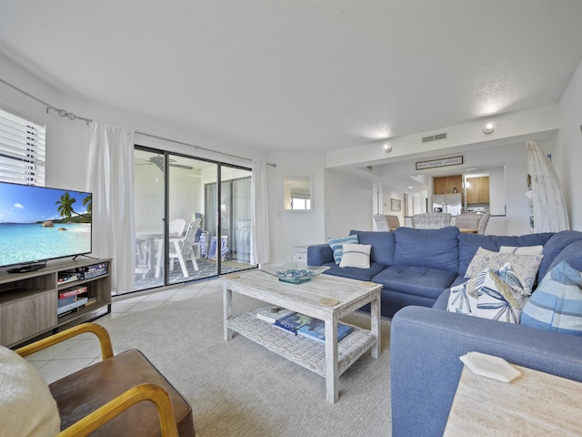 living room with a healthy amount of sunlight and light tile patterned floors