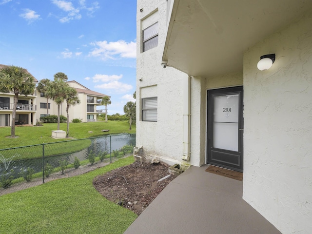 property entrance featuring a lawn