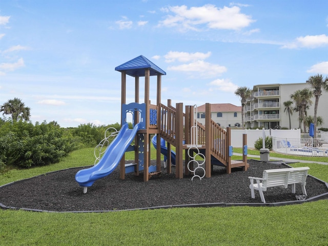 view of playground with a lawn