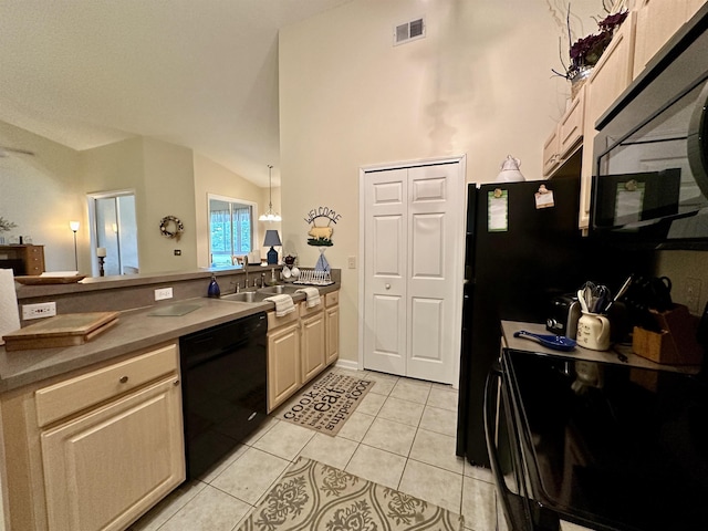 kitchen with black appliances, sink, vaulted ceiling, light tile patterned floors, and decorative light fixtures