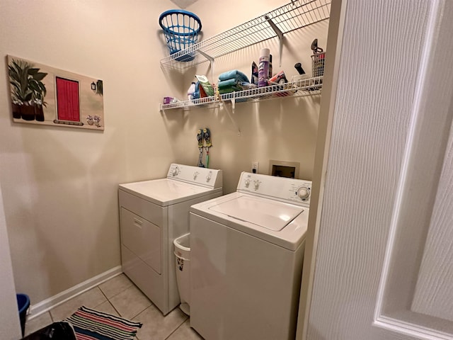 washroom featuring light tile patterned floors and washing machine and clothes dryer