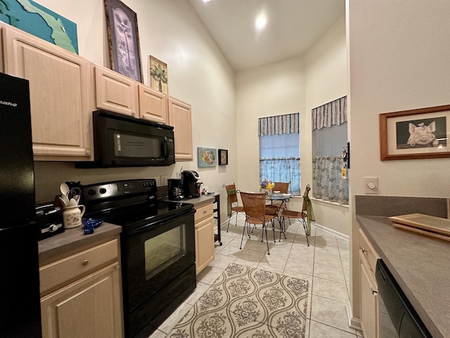 kitchen with light tile patterned floors, light brown cabinets, high vaulted ceiling, and black appliances