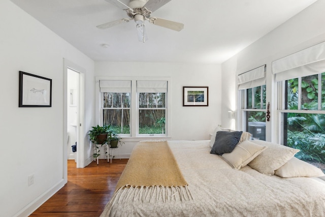 bedroom with ceiling fan and dark hardwood / wood-style flooring