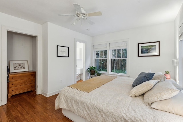 bedroom featuring ceiling fan, dark wood-type flooring, and ensuite bath