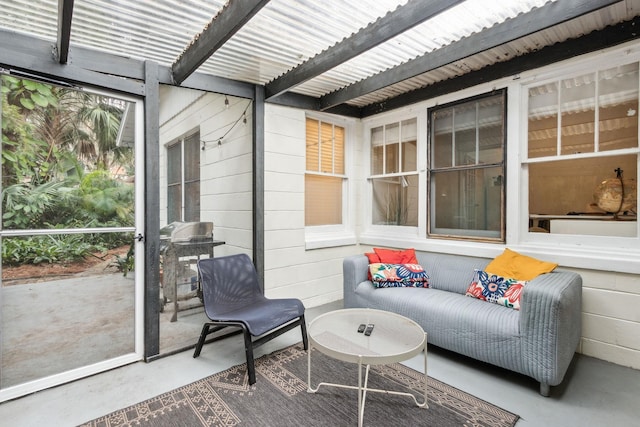 sunroom featuring beam ceiling