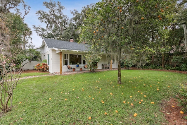 view of front of property featuring a patio area and a front lawn