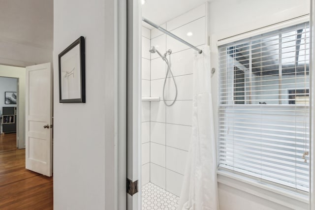 bathroom featuring curtained shower and wood-type flooring