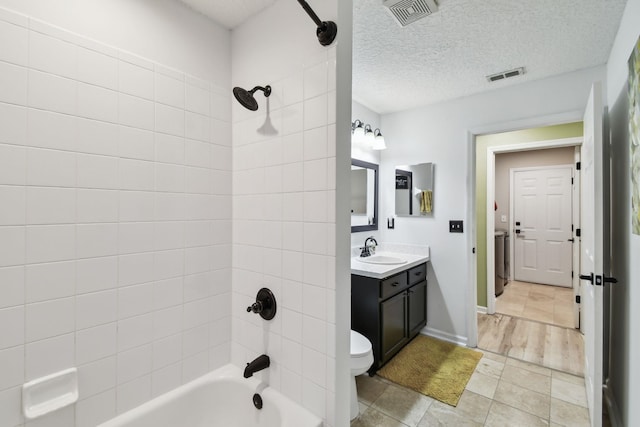 bathroom with visible vents, vanity, a textured ceiling, and shower / bathtub combination