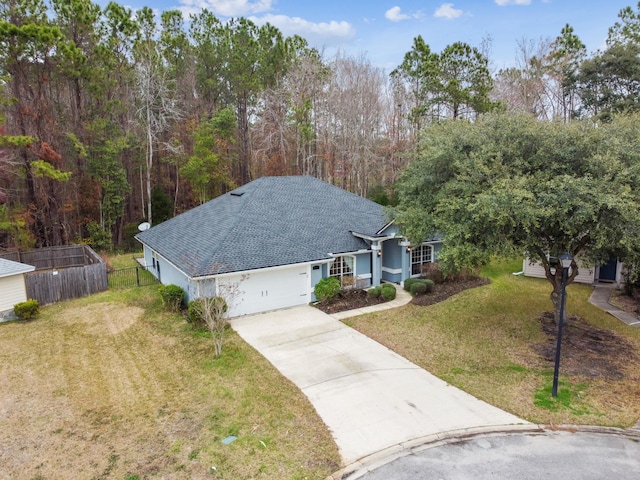 view of front of home with a garage and a front lawn