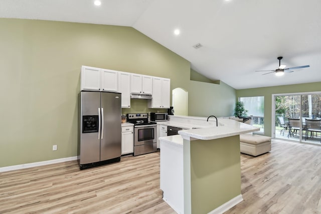 kitchen with light countertops, appliances with stainless steel finishes, white cabinets, a sink, and a peninsula