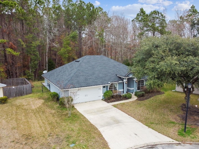 view of front facade with a garage and a front lawn