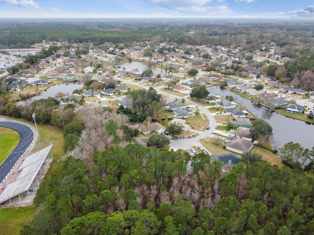 drone / aerial view featuring a residential view and a water view