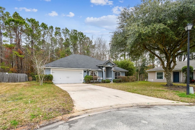 single story home with a garage, concrete driveway, a front yard, and fence