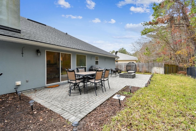 exterior space featuring an outdoor fire pit and fence