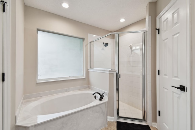 full bath featuring a textured ceiling, a stall shower, a bath, and recessed lighting