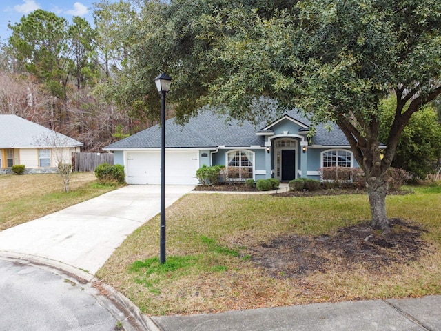 ranch-style home with a garage, fence, driveway, stucco siding, and a front lawn