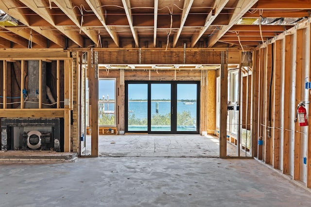 miscellaneous room featuring a fireplace and a water view