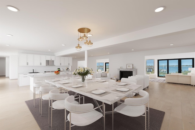 dining room with a notable chandelier and light wood-type flooring