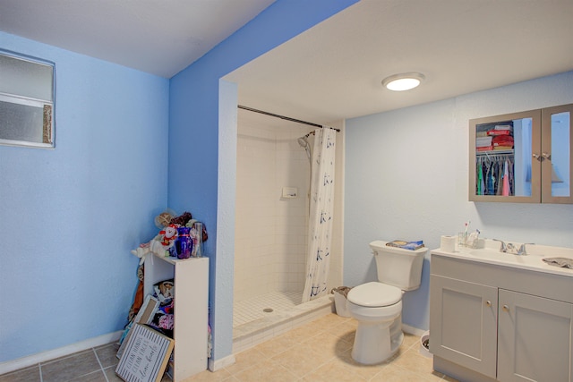 bathroom featuring toilet, tile patterned flooring, vanity, and walk in shower