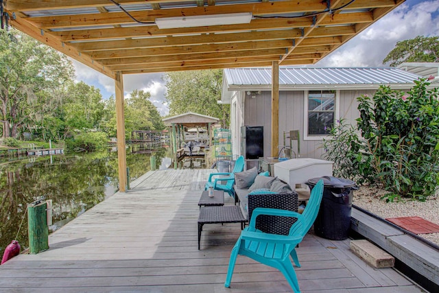 deck with a dock and a water view