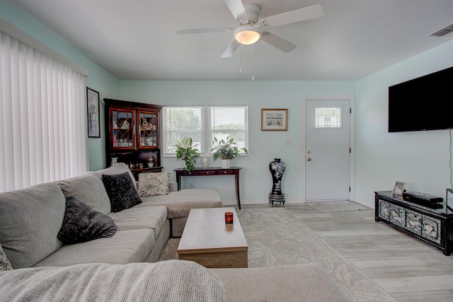 living room featuring ceiling fan and light hardwood / wood-style flooring