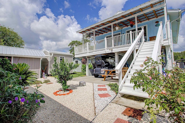 exterior space with covered porch and a carport