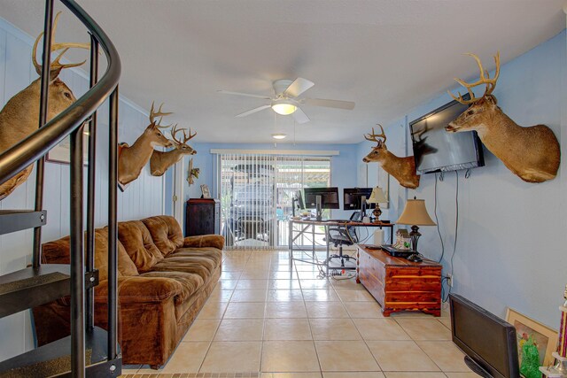 living room with ceiling fan and light tile patterned floors