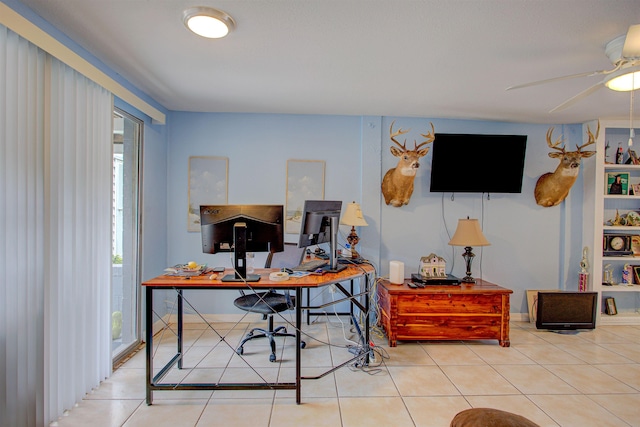 tiled office featuring ceiling fan