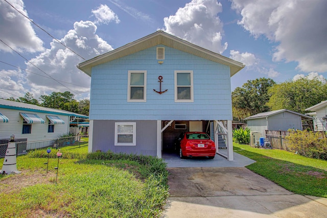 view of front of property with a carport and a front yard