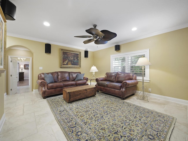 living room with ceiling fan and ornamental molding