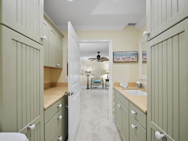 bathroom with ceiling fan, ornamental molding, and vanity