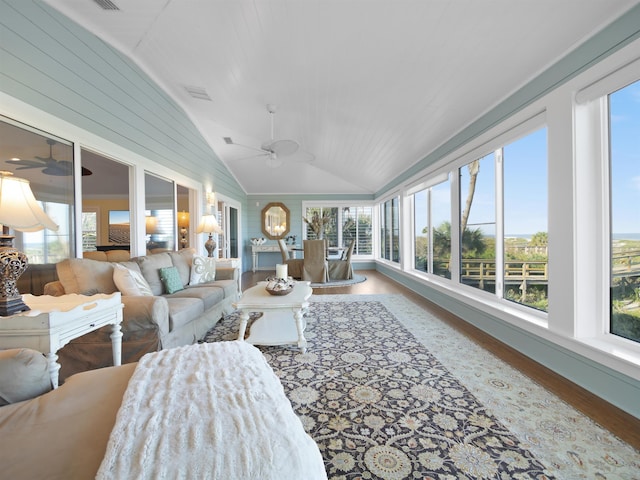 sunroom / solarium featuring ceiling fan, a healthy amount of sunlight, and lofted ceiling