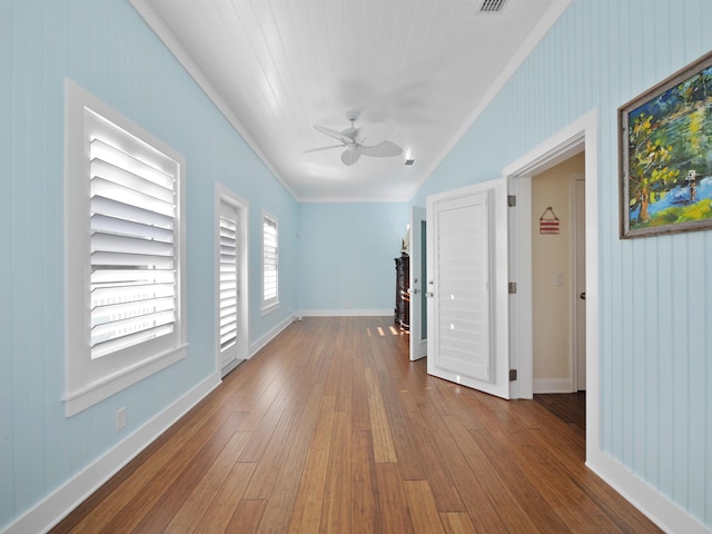 spare room featuring hardwood / wood-style floors, ceiling fan, and crown molding