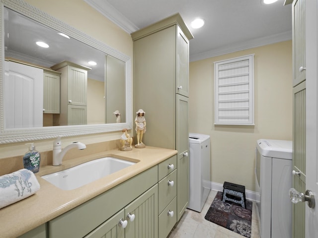 bathroom featuring vanity, washer and dryer, and ornamental molding