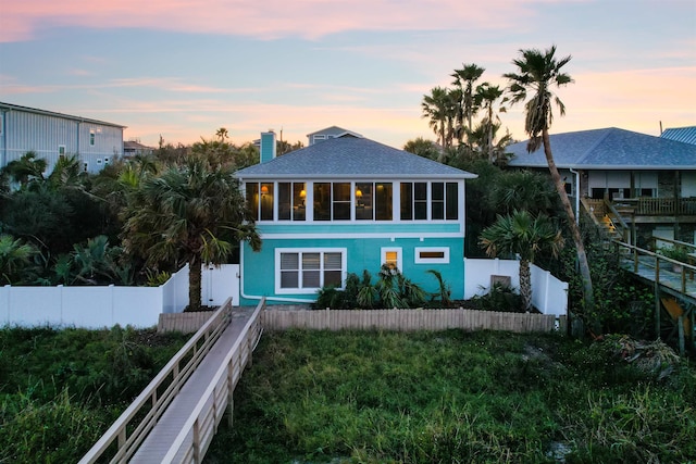 view of back house at dusk