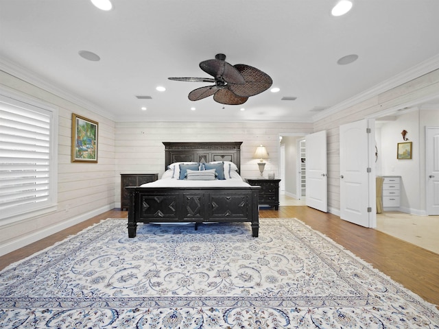 bedroom with ceiling fan, light wood-type flooring, and crown molding