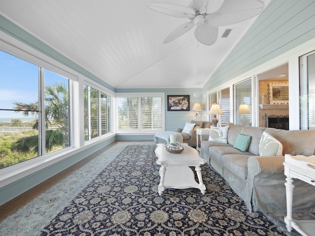 sunroom featuring ceiling fan and vaulted ceiling