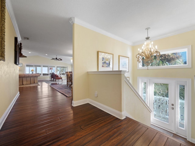 entryway featuring dark hardwood / wood-style floors, ornamental molding, ceiling fan with notable chandelier, and lofted ceiling