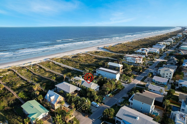 drone / aerial view with a water view and a beach view