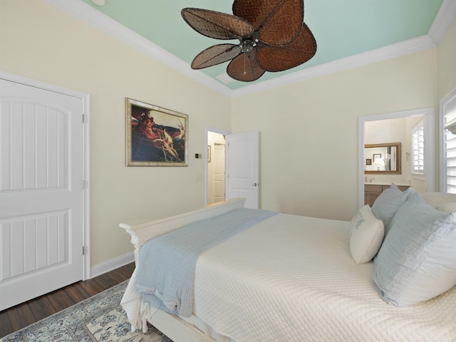 bedroom with ensuite bath, ceiling fan, crown molding, and dark wood-type flooring